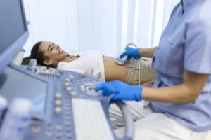 ultrasound diagnostic stomach abdominal woman clinic closeup view doctor runs ultrasound sensor patient s girl tummy looks image screen diagnosis internal organs