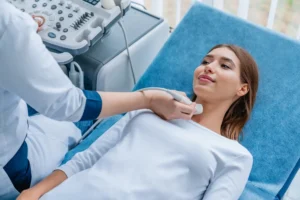 young woman having neck ultrasound scanning examination by her doctor modern clinic